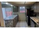 Kitchen featuring new stainless steel appliances, gray cabinets and tiled floors at 746 Dunaire Way, Jonesboro, GA 30238