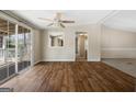 Bright room with luxury vinyl plank floors, sliding glass doors to outside deck and ceiling fan at 261 Lakeview Dr, Locust Grove, GA 30248