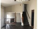 Bright living room featuring a cozy fireplace, and stairs with wood railing leading up at 1574 Elizabeth Ln, Hampton, GA 30228