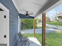 Relaxing front porch featuring a ceiling fan and decorative metal chair at 340 Cedar St, Social Circle, GA 30025