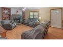 Spacious living room featuring wood floors and a stone fireplace at 2643 Rocky Creek Rd, Hampton, GA 30228