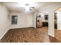 Spacious living room featuring wood-look floors and arched doorways leading to kitchen and dining areas at 323 Lauren Dr, Fairburn, GA 30213