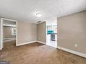 Spacious living room with neutral walls and kitchen view at 927 Dean Patrick Rd, Locust Grove, GA 30248