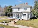 Inviting two-story home with a classic front porch, set on a well-maintained lawn and landscaped grounds at 76 College St, Mcdonough, GA 30253