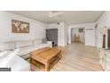 Bright living room with light-colored wood floors, white sofa and white walls at 3529 Essex Ave # 75, Atlanta, GA 30339
