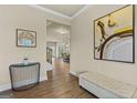 Inviting foyer featuring wood-look floors, neutral walls, and a decorative console table, creating a warm ambiance at 2377 Aukerman Trce # 82, Hampton, GA 30228
