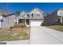 Charming two-story home with attached two car garage, beautiful landscaping and covered front porch at 7754 Hansel Ln, Lithonia, GA 30058