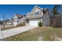 Exterior view of beautiful two story home with attached two car garage and long driveway at 7754 Hansel Ln, Lithonia, GA 30058