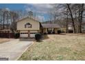 Charming split-level home with a well-maintained lawn and mature trees at 4161 Windermere Dr, Lithonia, GA 30038