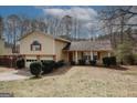 Charming split-level home with a well-maintained lawn, mature trees, and a two-car garage at 4161 Windermere Dr, Lithonia, GA 30038