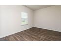 Bright, airy bedroom with hardwood floors and natural light streaming through the window at 1037 Claas Way, Locust Grove, GA 30248
