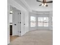 Spacious primary bedroom with neutral carpet, a tray ceiling and a bright bay window at 1654 Summersweet Ln, Dacula, GA 30019