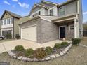 Beautiful home exterior with a brick facade, attached garage, and landscaped front yard at 789 Galveston Way, Mcdonough, GA 30253