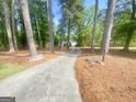 A long driveway winds through the trees up to a charming home at 848 Still Rd, Lawrenceville, GA 30045