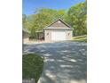 A detached garage with a white door sits at the end of a concrete driveway at 848 Still Rd, Lawrenceville, GA 30045