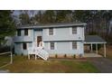 Charming two-story home with a covered parking area and classic white trim details at 5865 Vernier Dr, Atlanta, GA 30349
