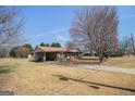 Brick home with a covered parking area and spacious yard at 143 Teamon Rd, Hampton, GA 30228