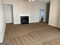 Spacious living room featuring a fireplace and neutral carpet at 165 Lakeside Pt, Covington, GA 30016