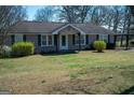 Lovely home featuring a well-maintained lawn and cozy front porch at 123 Cowan Rd, Covington, GA 30016