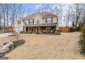 Charming two-story home featuring a welcoming front porch and a spacious front yard at 4006 Asheville Ct, Buford, GA 30519