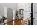 Elegant foyer with hardwood floors, staircase, and decorative wall paneling at 4006 Asheville Ct, Buford, GA 30519