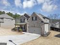 Two story home with two car garage and lush side yard landscaping at 10736 Southwood Dr, Hampton, GA 30228