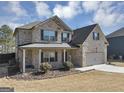 Charming two-story brick home with a two-car garage and well-manicured front lawn at 10736 Southwood Dr, Hampton, GA 30228