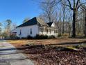 Classic single-story home with a covered front porch, situated on a large lot with a mature tree line at 2680 Noahs Ark Rd, Jonesboro, GA 30236