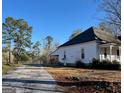A single-story home on a spacious lot, offering a sense of privacy with mature trees and open yard space at 2680 Noahs Ark Rd, Jonesboro, GA 30236
