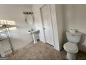 Bathroom features a white toilet and sink, as well as tile flooring at 6160 Great Oaks Dr, Lithonia, GA 30058