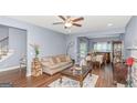 Bright living room with hardwood floors, an open floor plan, and neutral decor for a cozy feel at 275 Bramble Bush Trl, Covington, GA 30014