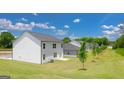 Expansive backyard featuring a white vinyl siding, green lawn, and new construction homes in a Gathering-friendly community at 8595 Secretariat Dr # 19, Lithonia, GA 30058