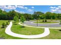 Well-maintained landscaping with sidewalks and winding streets creating a welcoming and pedestrian-friendly community environment at 8595 Secretariat Dr # 19, Lithonia, GA 30058