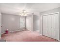 Bedroom featuring neutral walls, a ceiling fan, and ample closet space for storage at 149 Crown Oaks Dr, Stockbridge, GA 30281
