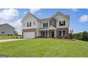 Beautiful two-story home with mixed brick and shingle facade, offering a well-manicured lawn at 127 Felicity Pike, Locust Grove, GA 30248
