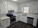 Bright kitchen featuring white cabinets, marble countertops, and stainless steel appliances at 554 Fieldstream Way, Lawrenceville, GA 30044