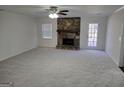 Cozy living room with a stone fireplace and neutral carpet at 554 Fieldstream Way, Lawrenceville, GA 30044