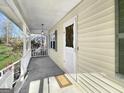 Inviting covered front porch, perfect for relaxing and enjoying the outdoors with a view to the yard at 114 Mcbride Rd, Fayetteville, GA 30215