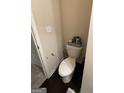 Tight shot of a bathroom toilet with a wall mounted decor piece on the tank at 6001 Nile Ct, Atlanta, GA 30349