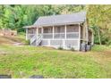 Lovely single-story home with a screened porch, surrounded by a well-manicured lawn and mature trees at 4481 Mclain Cir, Acworth, GA 30101