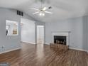 Cozy living room with fireplace, ceiling fan and wood-look flooring at 255 Brandon Ridge Cir, Stockbridge, GA 30281