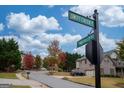 Neighborhood street view showcasing the community's street signs, well-kept homes, and lush landscaping at 5825 Trailwood Ct, Suwanee, GA 30024