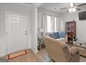 Bright living room with a cream couch, a dark wood bookcase, and a cozy recliner at 340 Layfield Dr, Jonesboro, GA 30238