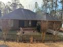 The back of the brick home includes a patio and fenced yard at 5207 Sw West Shore Dr, Conyers, GA 30094