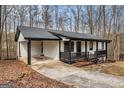 Home exterior featuring a car port, covered porch, and black accents at 1436 Heritage Ct, Villa Rica, GA 30180