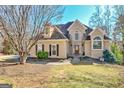 Inviting two-story home boasting an arched entryway, manicured lawn, and a beautifully landscaped front yard at 417 Plantain Ter, Peachtree City, GA 30269