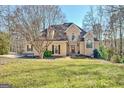 Charming two-story house with a well-maintained lawn and mature trees in a landscaped front yard at 417 Plantain Ter, Peachtree City, GA 30269