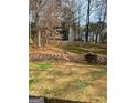 Large backyard featuring a stone retaining wall and swing set at 1121 Valley Ridge, Marietta, GA 30067