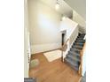 Bright foyer featuring hardwood floors, staircase, and a stylish rug at 5625 Jamerson Dr, South Fulton, GA 30349