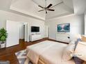 Spacious main bedroom features hardwood floors, a ceiling fan, and ample closet space; virtually staged at 10067 Freeman Ct, Jonesboro, GA 30236